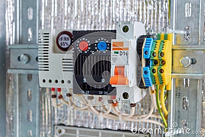 In the electrical Cabinet circuit breaker, thermostat, terminals. Stock Photo