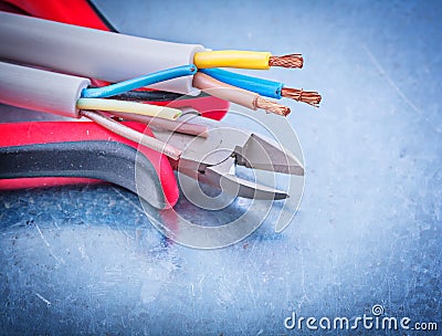 Electrical cables wires cutting pliers on metallic background co Stock Photo