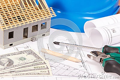 Electrical construction drawings, work tools and accessories, small toy house and currencies dollar, building home cost concept Stock Photo