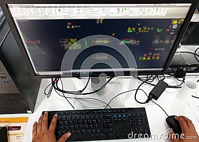 Electrical draftsman working on the computer monitor with typing keyboard and mouse Stock Photo