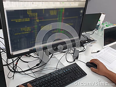 Electrical draftsman working on the computer monitor with typing keyboard and mouse Stock Photo