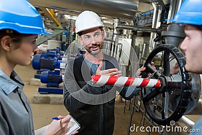 Electrical engineer with apprentices working at control room Stock Photo