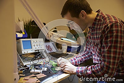 Electrical Engineer Soldering Circuit Board At Work Bench Stock Photo