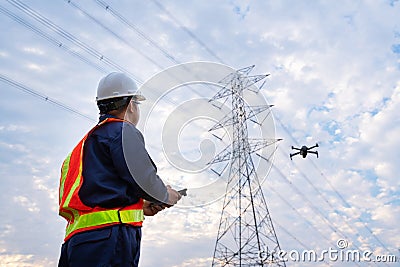 An electrical engineer or technician location use drone to fly inspections at the electric power station to view the planning work Stock Photo