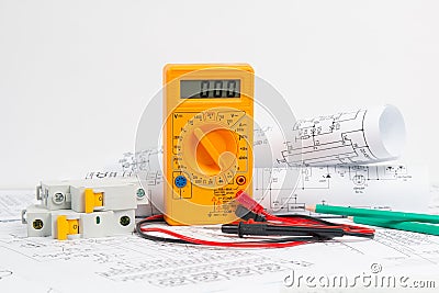 Electrical engineering drawings, circuit breaker, pencils and digital multimeter Stock Photo