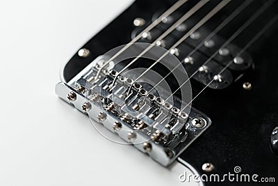 Electrical guitar bridge and metal strings closeup. Electric guitar black and white color, detail. Music instruments Stock Photo