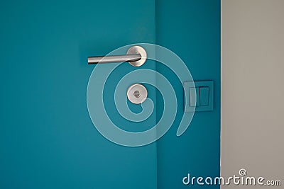 Electrical household navy blue switches in minimalist interior design. Stylish bedroom and livingroom door handle Stock Photo