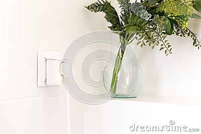 Electrical outlet with smart plug on modern bright bathroom Stock Photo