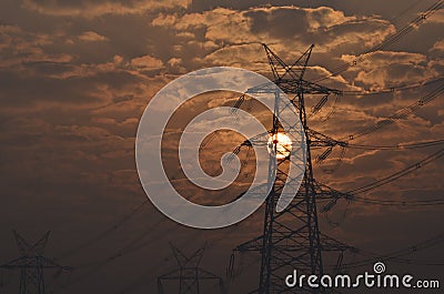 Electrical pylon and high voltage power lines near transformation station at Sunrise in Gurgaon Stock Photo