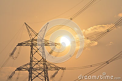 Electrical pylon and high voltage power lines near transformation station at Sunrise in Gurgaon Stock Photo