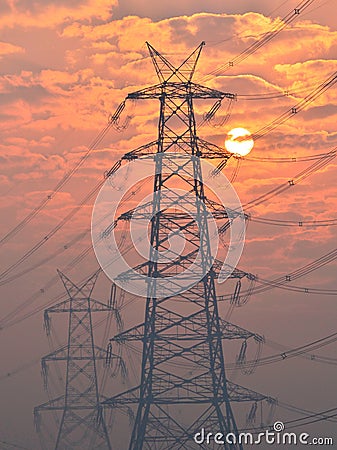 Electrical pylon and high voltage power lines near transformation station at Sunrise in Gurgaon Stock Photo