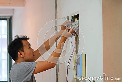 Electrical renovation work, Man install Industrial electrical equipment Stock Photo