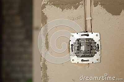 Electrical socket hole on concrete wall. Under construction electrical socket Stock Photo