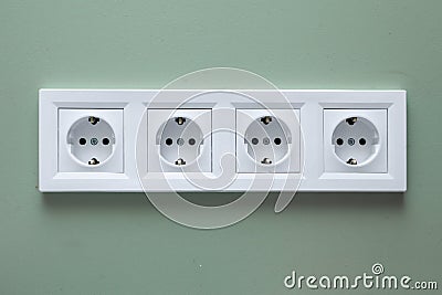 Electrical socket white on four jacks Stock Photo