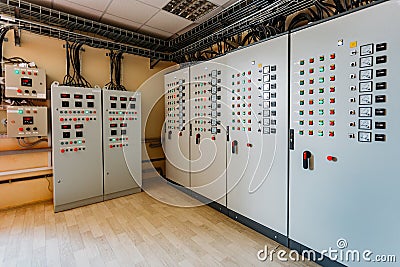 Electrical switchgear cabinets with control panels with indicator lights in factory Stock Photo