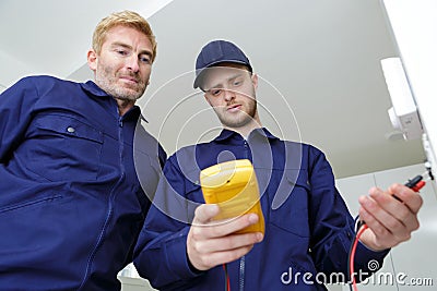 electrical technicians measure current Stock Photo