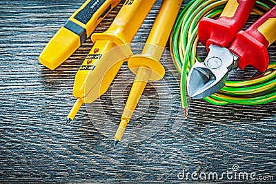 Electrical tester nippers rolled wire on wood board Stock Photo