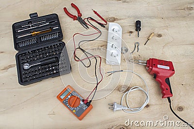 Electrical tools meter, soldering iron, keys and electrical materials, splitter, cable Electric, tin and screwdrivers are lying Stock Photo