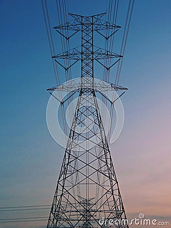Electrical Transmission power line tower post pole against blue sky Stock Photo