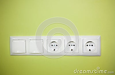 Electrical wall outlet / on green background Stock Photo