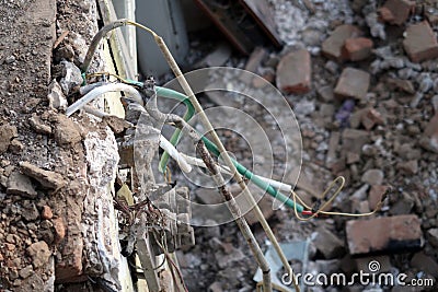 Electrical wires from ceiling from demolished house Stock Photo