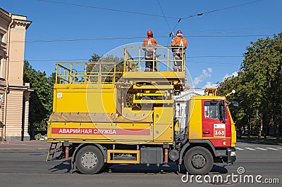 Electrical workers on a car of the emergency service of urban electric transport. Saint Petersburg Editorial Stock Photo