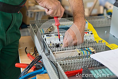 Electrician assembling industrial electric cabinet. Stock Photo