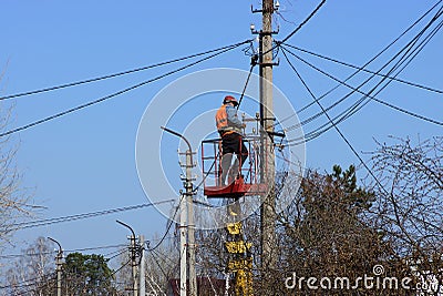 The electrician is changing the wires on the pole Editorial Stock Photo