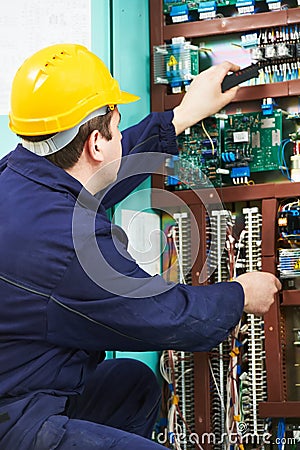 Electrician checking current at power line box Stock Photo