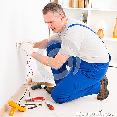 Electrician checking socket Stock Photo