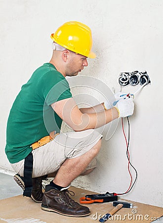 Electrician checking voltage Stock Photo