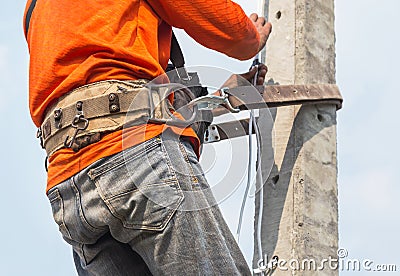 Electrician climb working in the height on the pole with safety belt Editorial Stock Photo