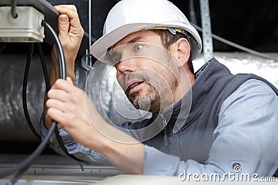 Electrician connecting power cable Stock Photo