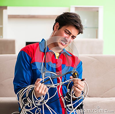 Electrician contractor with tangled cables Stock Photo