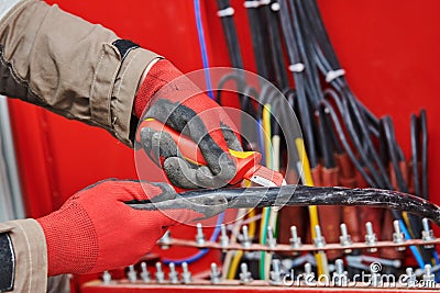 Electrician cutting cable isolation with knife Stock Photo