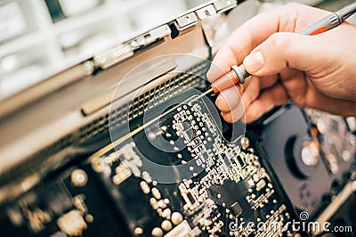 Electrician engineer technician repair faulty computer monitor in electr service Stock Photo