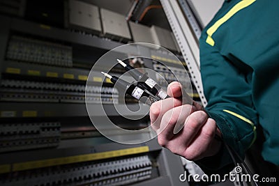 Electrician engineer is testing electrical equipment at a large plant. Editorial Stock Photo