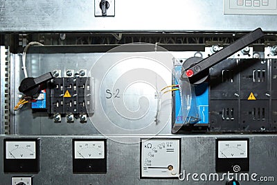 Electrician engineer work tester measuring voltage and current of power electric line in electical cabinet control.and Editorial Stock Photo