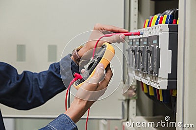 Electrician engineer work tester measuring voltage . Stock Photo