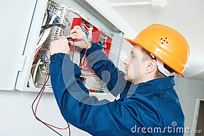 Electrician examining current voltage with screwdriver tester Stock Photo