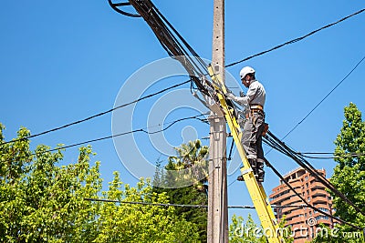 Electrician fixing the cables on the pole of the city network in Editorial Stock Photo