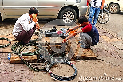 Electrician fixing cables on the street Editorial Stock Photo
