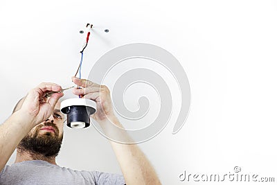 Electrician Installing Celling Light Stock Photo