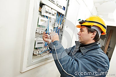 Electrician installing energy saving meter Stock Photo