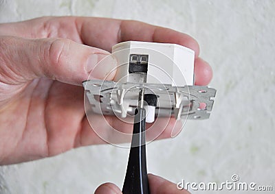 Electrician installing and repair a dimmer switch in a wall socket. Light switch dimmer Stock Photo