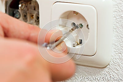 Electrician installing socket Stock Photo