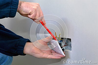 Electrician installing a socket Stock Photo