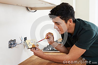 Electrician Installing Socket In New House Stock Photo