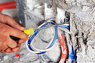 Electrician installing a switch socket Stock Photo