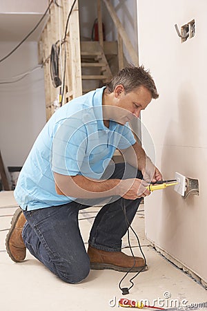 Electrician Installing Wall Socket Stock Photo